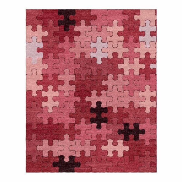 Tapis touffeté en forme de puzzle présentant diverses nuances de rouge, rose et bordeaux pièces de puzzle.